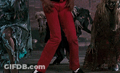 A Man In A Red Jacket Says Aaow In Front Of A Group Of Zombies GIF