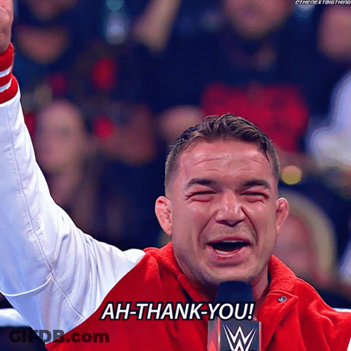 A Man In A Red Jacket Says Ah-Thank-You In Front Of A Microphone GIF