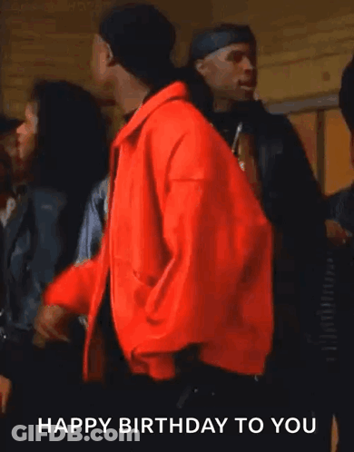 A Man In A Red Jacket Says " Happy Birthday To You " While Smoking A Cigarette GIF