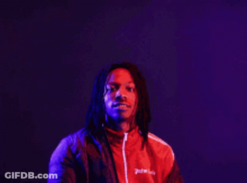A Man In A Red Jacket Stands In Front Of A Sign That Says The More You Know GIF