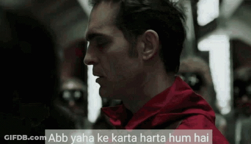 A Man In A Red Jacket With The Words Abb Yaha Ke Karta Harta Hum Hai Above Him GIF