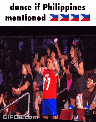 A Man In A Red Jersey With The Number 37 On It Stands In Front Of A Crowd GIF