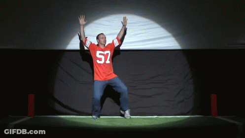 A Man In A Red Jersey With The Number 52 On It Is Dancing GIF