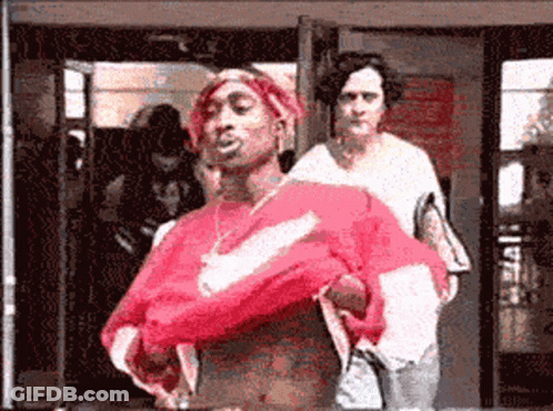 A Man In A Red Nike Shirt Is Standing In Front Of A Woman GIF