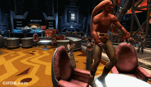 A Man In A Red Outfit Is Standing In A Room GIF
