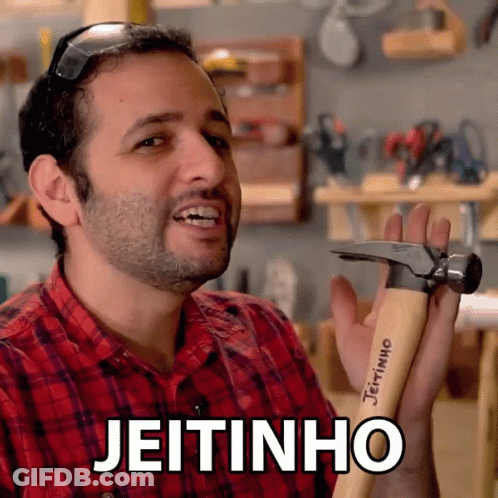 A Man In A Red Plaid Shirt Is Holding A Hammer With The Word Jeitinho Written On It GIF