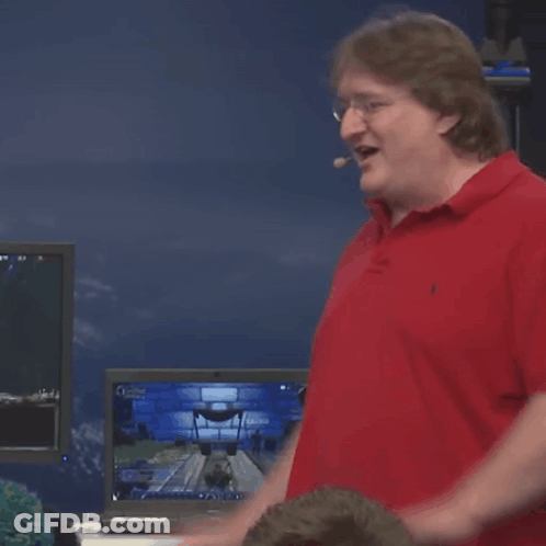 A Man In A Red Polo Shirt Is Standing In Front Of A Computer Screen GIF