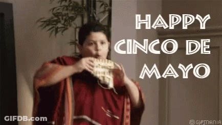 A Man In A Red Poncho Is Eating A Taco . GIF