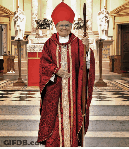 A Man In A Red Robe And Red Hat Is Holding A Staff GIF