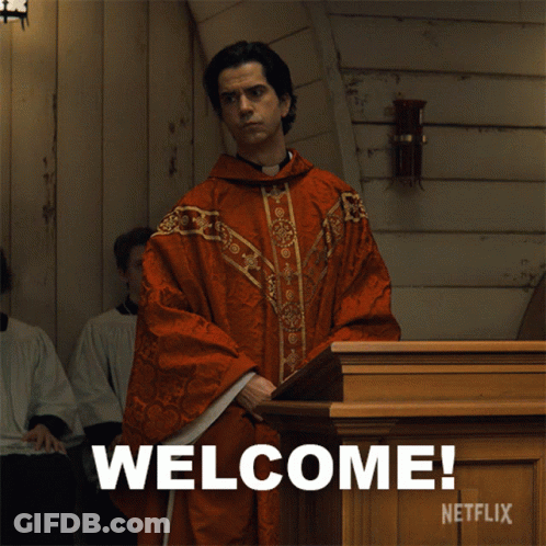 A Man In A Red Robe Is Standing In Front Of A Podium That Says Welcome Netflix GIF