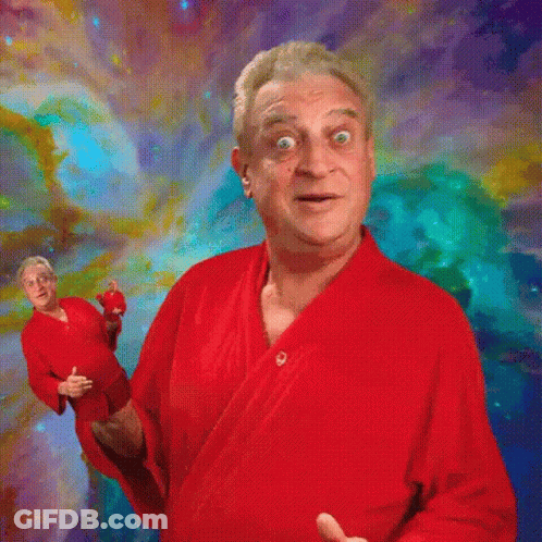 A Man In A Red Robe Stands In Front Of A Colorful Background . GIF