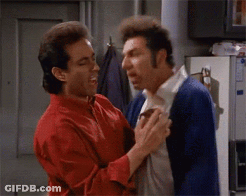 A Man In A Red Shirt And A Man In A Blue Cardigan Are Fighting GIF