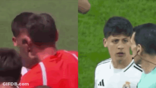 A Man In A Red Shirt And A Man In A White Adidas Shirt Are Standing Next To Each Other On A Field . GIF