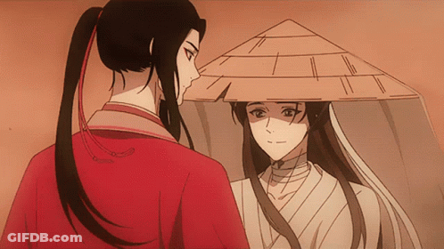 A Man In A Red Shirt And A Woman In A White Shirt Are Looking At Each Other GIF
