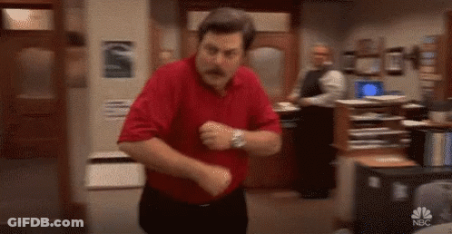 A Man In A Red Shirt And Black Pants Is Dancing In A Room . GIF