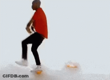 A Man In A Red Shirt And Black Pants Is Dancing On A White Background . GIF