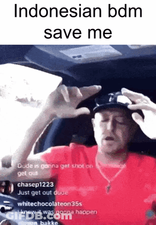 A Man In A Red Shirt And Hat Is Sitting In A Car With His Hands Up . GIF
