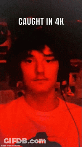 A Man In A Red Shirt Has The Words Caught In 4K Above Him GIF