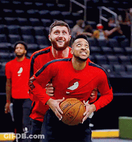 A Man In A Red Shirt Holding A Basketball That Says Dwight GIF