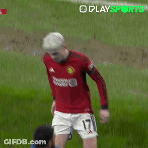 A Man In A Red Shirt Is Being Helped By A Man In A Yellow Jacket With Playsports Written In Green GIF