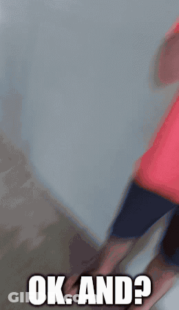 A Man In A Red Shirt Is Covering His Mouth With His Hand And Says Ok And GIF