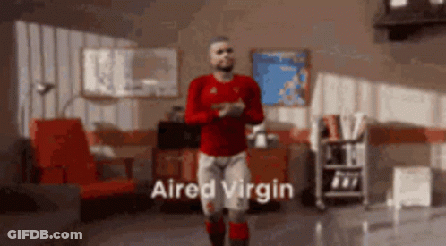 A Man In A Red Shirt Is Dancing In A Living Room With The Words " Aired Virgin " Written On The Bottom GIF