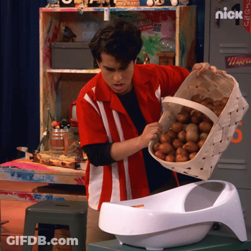 A Man In A Red Shirt Is Holding A Basket Of Potatoes In Front Of A Locker That Says Nick GIF