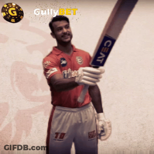 A Man In A Red Shirt Is Holding A Bat With A Ceat Logo On It GIF