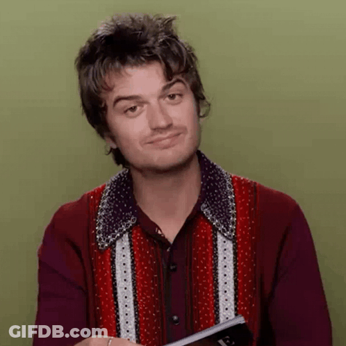 A Man In A Red Shirt Is Holding A Book And Making A Funny Face GIF