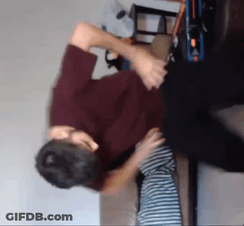 Man In Red Shirt Holding Child On Couch GIF