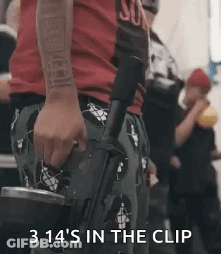 A Man In A Red Shirt Is Holding A Gun In His Hand And Says `` 3 14 'S In The Clip '' . GIF