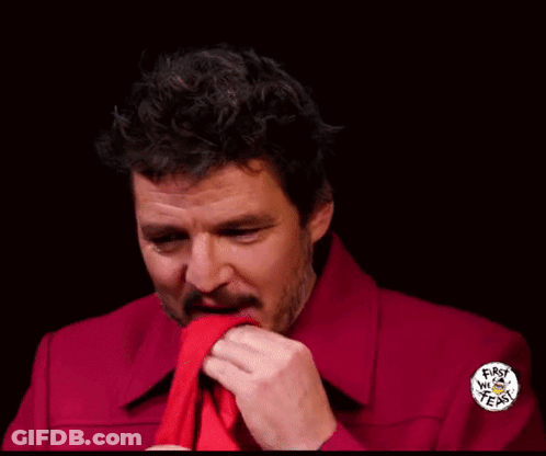 A Man In A Red Shirt Is Holding A Piece Of Paper With A Sticker On It That Says ' I Love You ' GIF