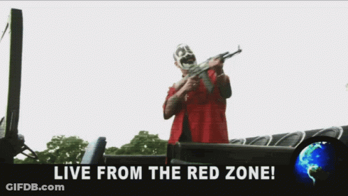 A Man In A Red Shirt Is Holding A Sword And The Words Fuck The World Live From The Red Zone GIF