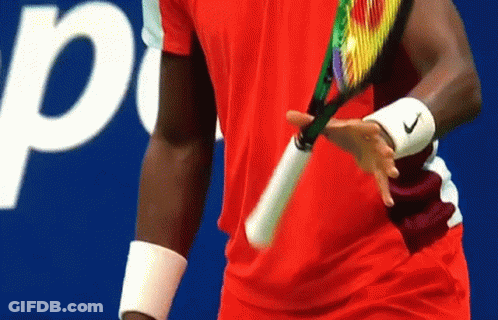 A Man In A Red Shirt Is Holding A Tennis Racquet In Front Of A Sign That Says Pepsi GIF