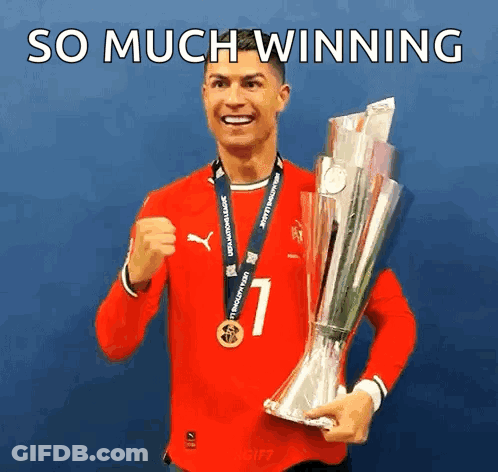 A Man In A Red Shirt Is Holding A Trophy With The Words So Much Winning Below Him GIF