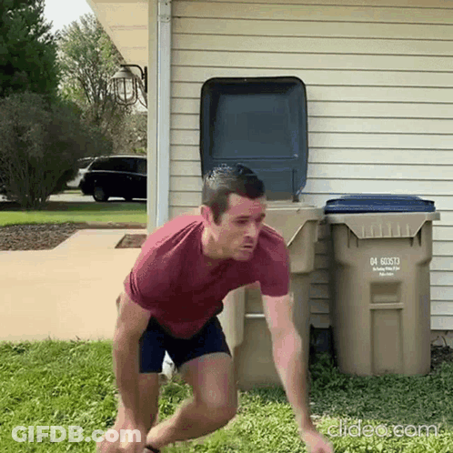 A Man In A Red Shirt Is Jumping In Front Of A Trash Can With The Number 04 On It .. GIF