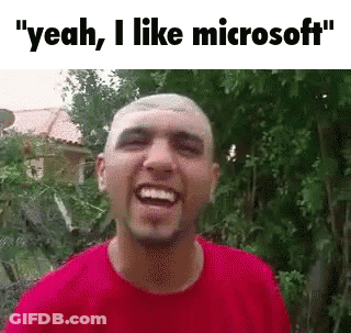 A Man In A Red Shirt Is Laughing With The Words `` Yeah , I Like Microsoft '' Above Him . GIF