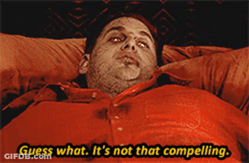 A Man In A Red Shirt Is Laying In Bed And Says Guess What It 'S Not That Compelling GIF
