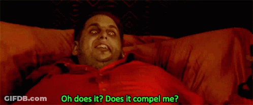A Man In A Red Shirt Is Laying In Bed With The Words Oh Does It Does It Compel Me Written Below Him GIF