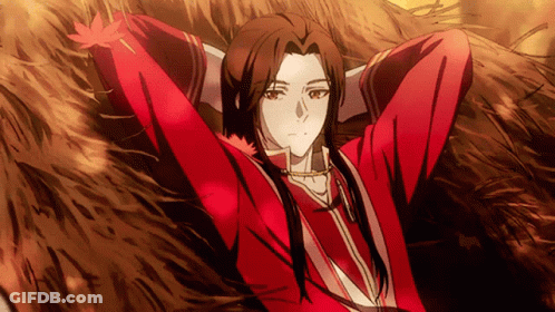A Man In A Red Shirt Is Laying In The Grass With His Arms Outstretched GIF