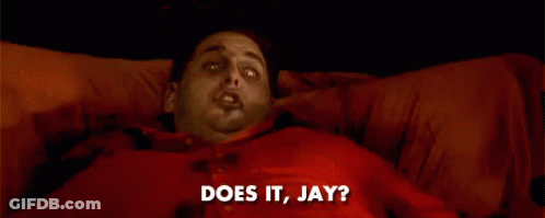 A Man In A Red Shirt Is Laying On A Bed And Says Does It Jay GIF