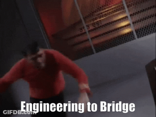 A Man In A Red Shirt Is Leaning On A Table With The Words Engineering To Bridge Written On The Bottom GIF