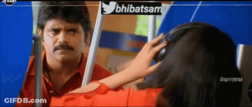 A Man In A Red Shirt Is Looking At A Woman In A Red Shirt With Headphones On GIF