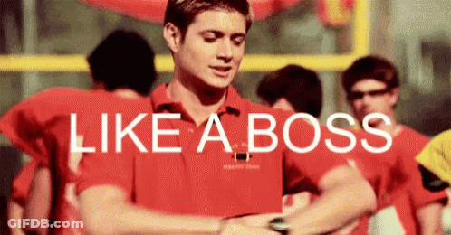 A Man In A Red Shirt Is Looking At His Watch With The Words Like A Boss Above Him . GIF