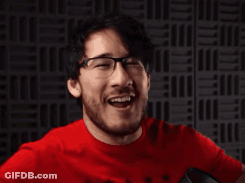A Man In A Red Shirt Is Making A Funny Face GIF