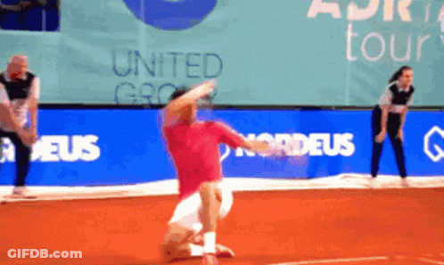 A Man In A Red Shirt Is Playing Tennis In Front Of A Banner That Says United Group GIF