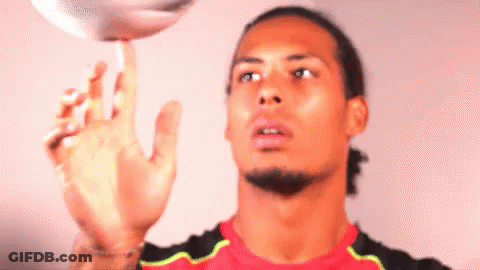A Man In A Red Shirt Is Playing With A Ball GIF