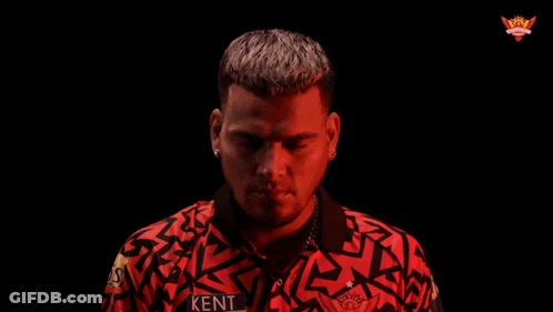 A Man In A Red Shirt Is Pointing At Something GIF