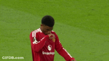 A Man In A Red Shirt Is Pointing Up In The Air . GIF