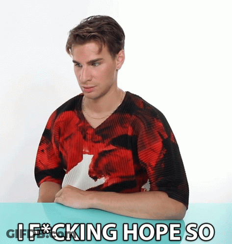 A Man In A Red Shirt Is Sitting At A Table With The Words I F * Cking Hope So Written Below Him GIF